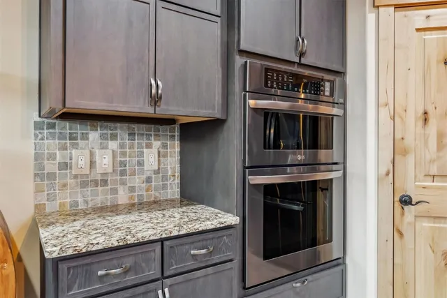 a kitchen with granite countertop cabinets stove and oven