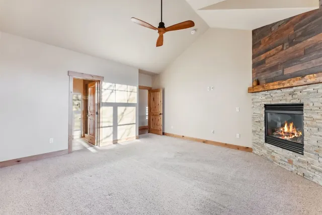 a view of an empty room with a window and a fireplace