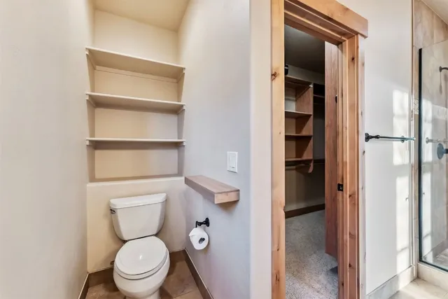 a white toilet sitting next to a bathroom sink
