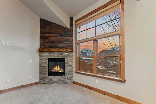 a living room with a fireplace and a window