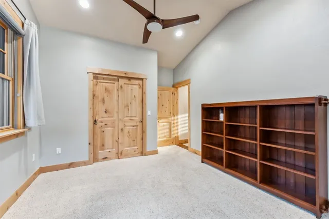 a view of empty room with wooden floor and windows