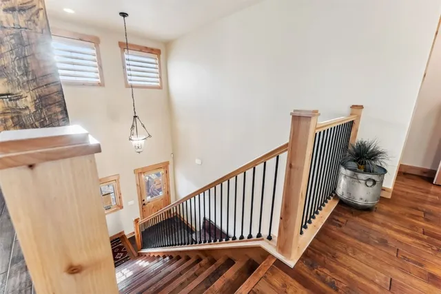 a view of a livingroom with wooden floor and stairs