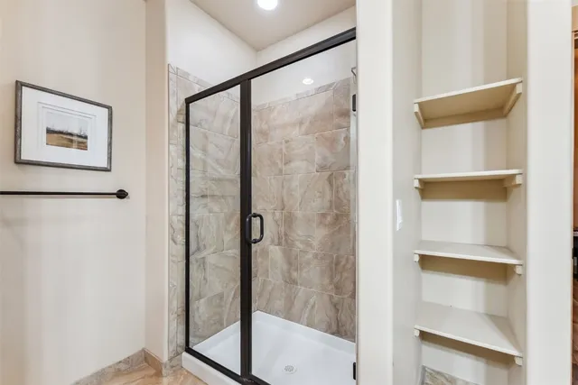 a bathroom with a glass shower door