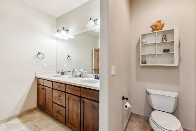 a bathroom with a toilet sink and mirror