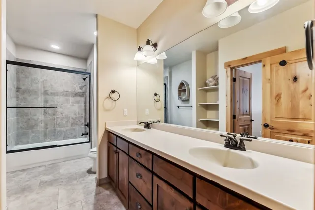 a bathroom with a sink double vanity and a shower