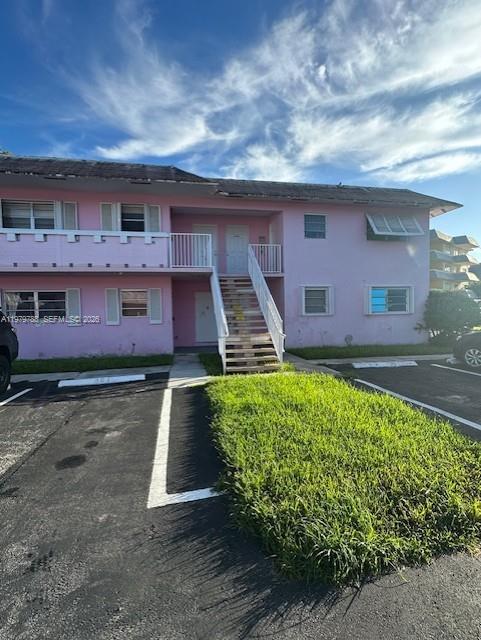 7500 Southwest 82nd Street, Unit G110 Miami, FL 33143 - Photo 1 of 13 a front view of a house with a yard