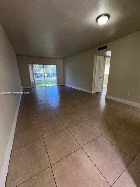 7500 Southwest 82nd Street, Unit G110 Miami, FL 33143 - Photo 2 of 13 an empty room with windows and entrance