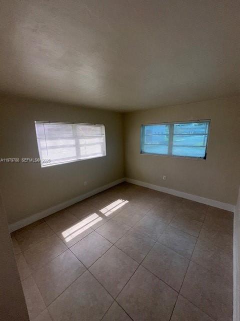 7500 Southwest 82nd Street, Unit G110 Miami, FL 33143 - Photo 5 of 13 a view of an empty room with a window