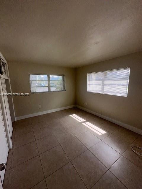 7500 Southwest 82nd Street, Unit G110 Miami, FL 33143 - Photo 7 of 13 a view of an empty room with a window