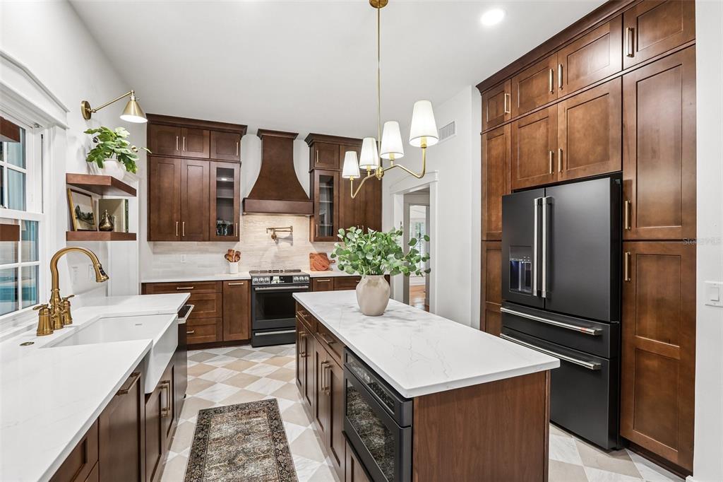1012 Morfield Lane Brandon, FL 33511 - Photo 20 of 100 a kitchen with stainless steel appliances granite countertop a sink stove and refrigerator