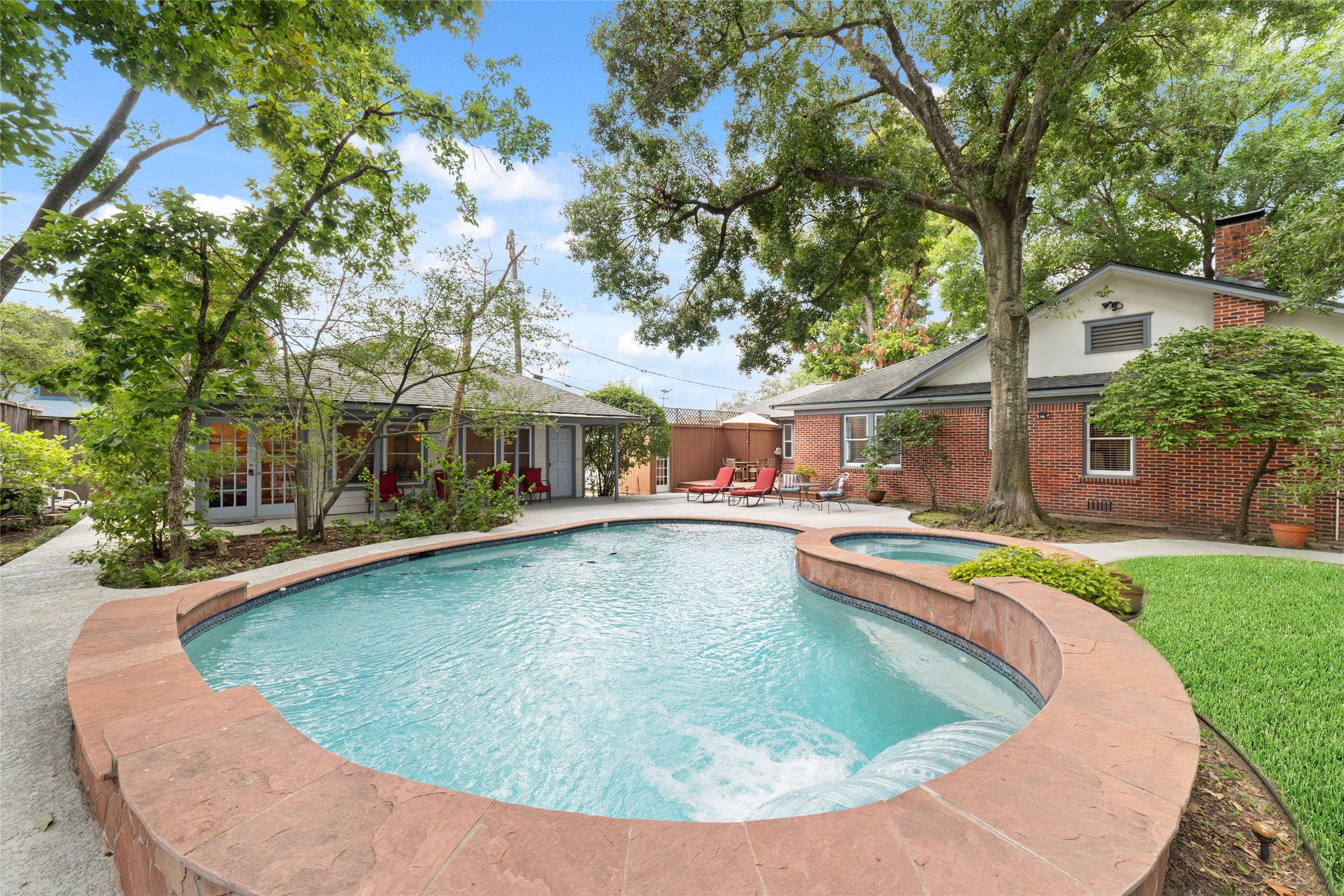 1613 California Street Houston, TX 77006 - Photo 6 of 50 Long before you notice the details inside, this backyard reminds you that home should feel like a destination. Heated saltwater pool, elevated spa, cascading waterfall, and complete privacy create an atmosphere that's difficult to leave behind.