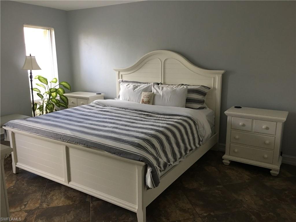 787 Palm View Drive, Unit 3 Naples, FL 34110 - Photo 11 of 19 a bedroom with a bed and a dresser