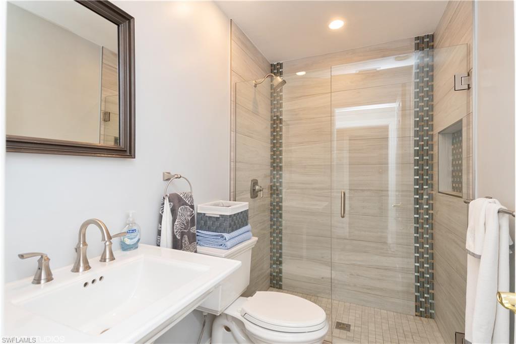 787 Palm View Drive, Unit 3 Naples, FL 34110 - Photo 14 of 19 a bathroom with a sink a toilet and shower
