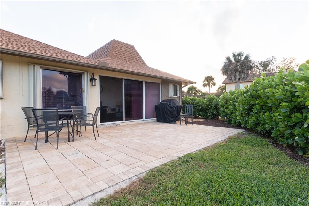 787 Palm View Drive, Unit 3 Naples, FL 34110 - Photo 16 of 19 a view of a house with backyard and sitting area