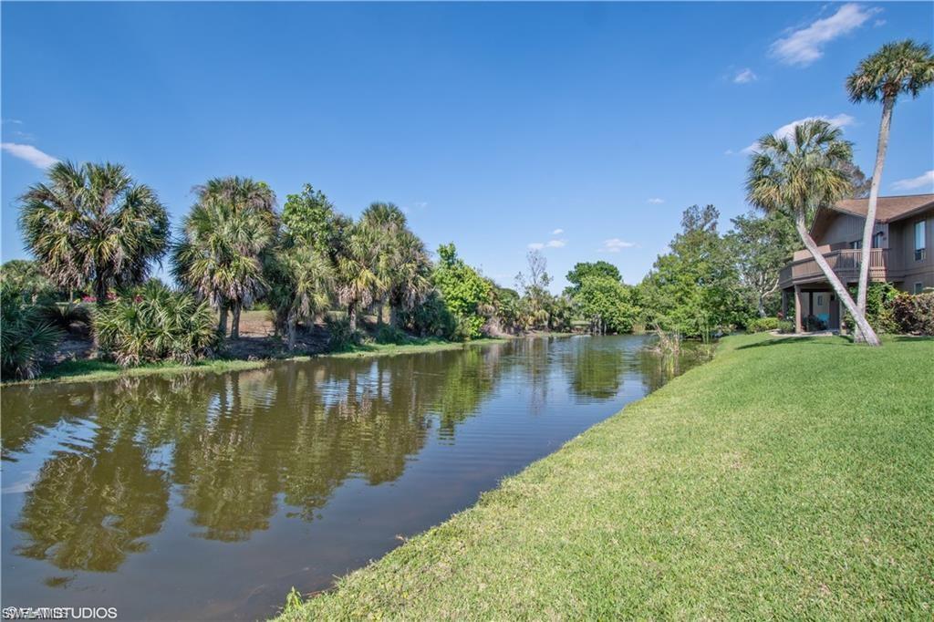 787 Palm View Drive, Unit 3 Naples, FL 34110 - Photo 19 of 19 a view of a lake with a building in the background