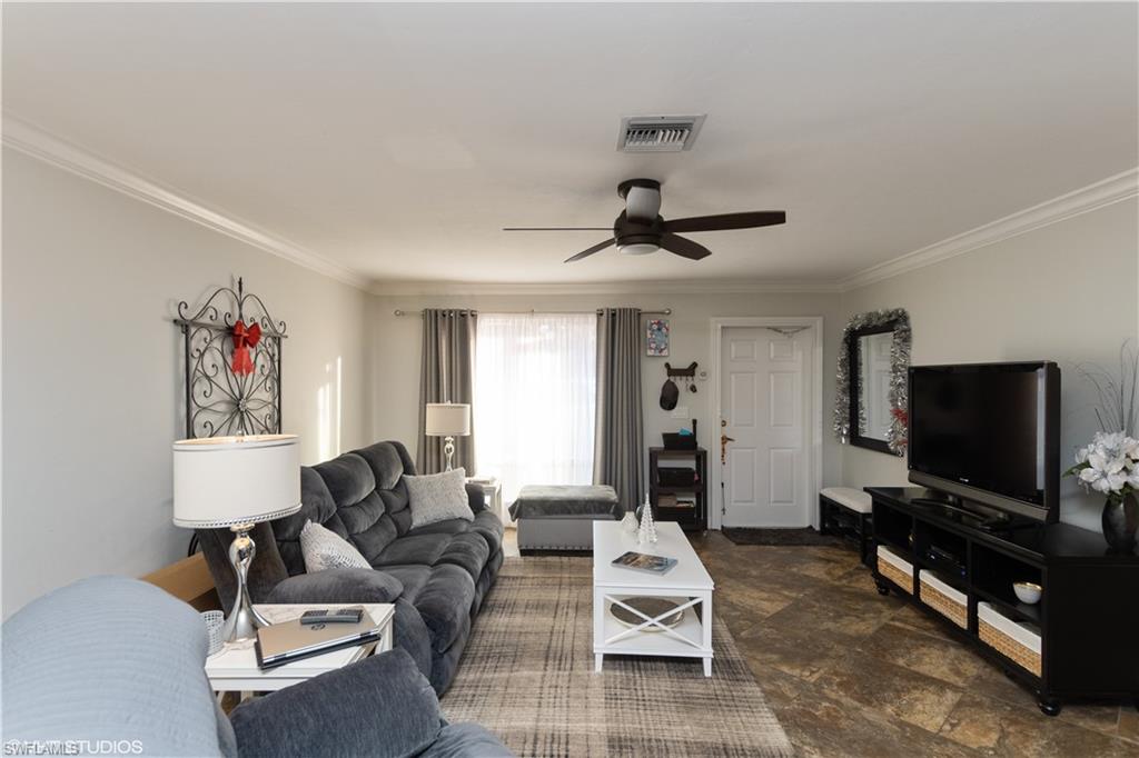 787 Palm View Drive, Unit 3 Naples, FL 34110 - Photo 5 of 19 a living room with furniture and a flat screen tv
