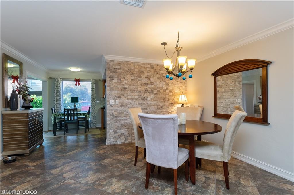 787 Palm View Drive, Unit 3 Naples, FL 34110 - Photo 7 of 19 a dining room with furniture a chandelier and window