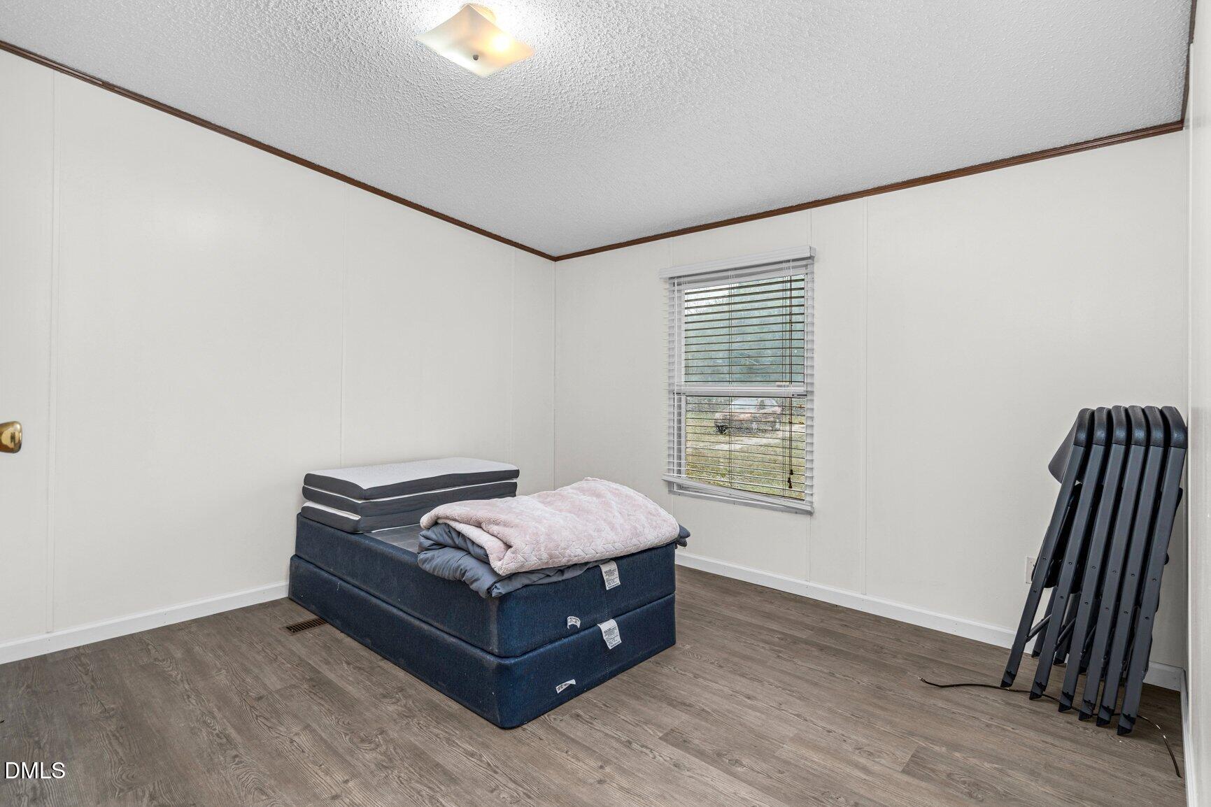 1835 Cokey Road Rocky Mount, NC 27801 - Photo 17 of 42 a room with a bed and a window