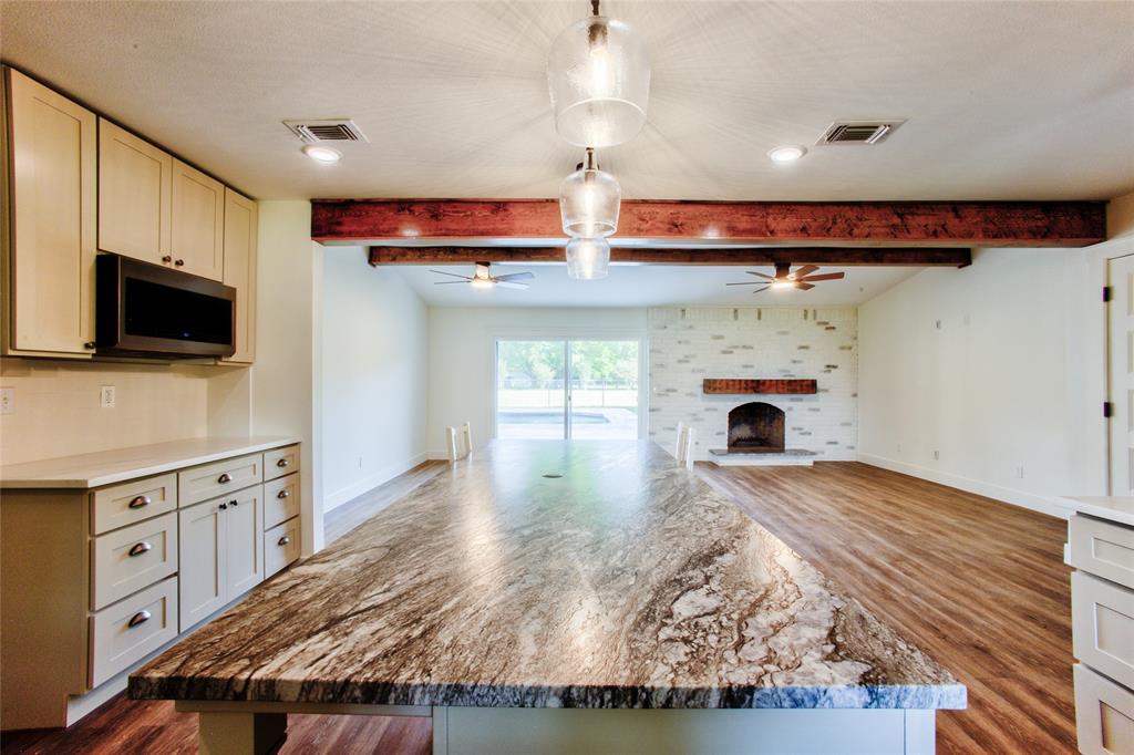 206 Americana Road Palmer, TX 75152 - Photo 13 of 40 The Longest View across the Kitchen Island through the Gathering Room & Out the Sliding Door/