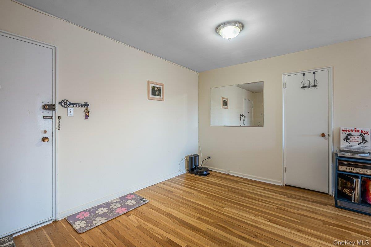 18-50 211th Street, Unit 6B Queens, NY 11360 - Photo 1 of 15 a room that has a bed and a wooden floor