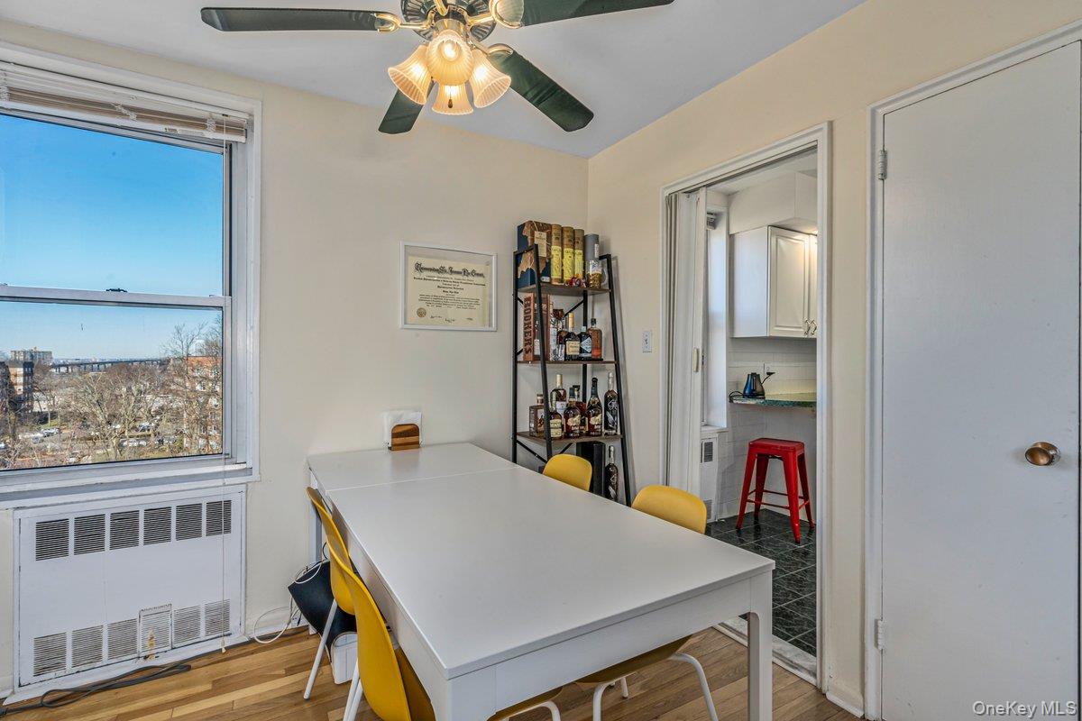 18-50 211th Street, Unit 6B Queens, NY 11360 - Photo 5 of 15 a view of a dining room with furniture and chandelier