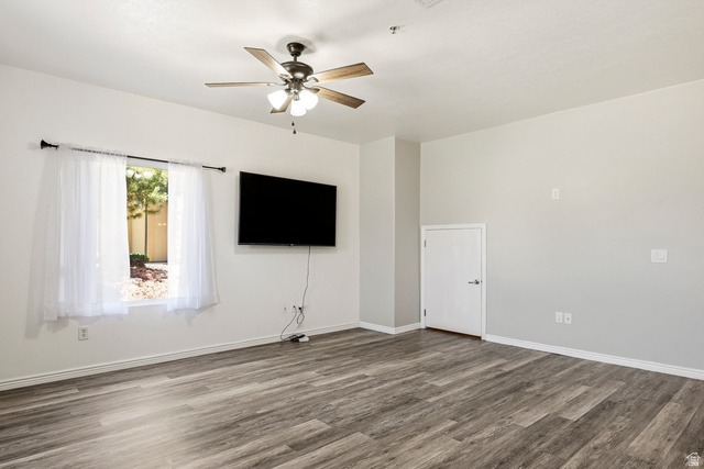 1177 Northfield Road, Unit 26 Cedar City, UT 84721 - Photo 4 of 45 Spacious room featuring wood-finish flooring, a contemporary ceiling fan, and ample natural light from a large window