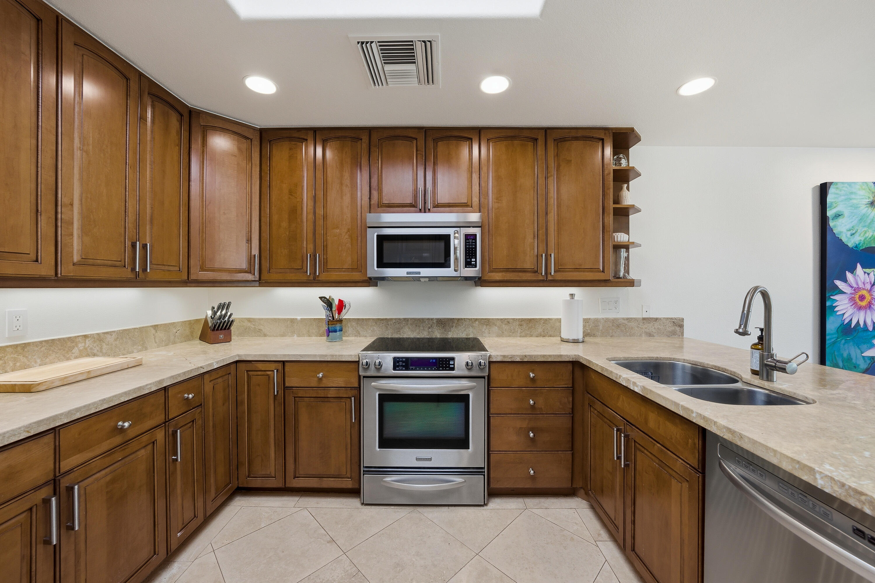 27 Cornell Drive Rancho Mirage, CA 92270 - Photo 11 of 58 a kitchen with stainless steel appliances granite countertop wooden cabinets sink stove and microwave