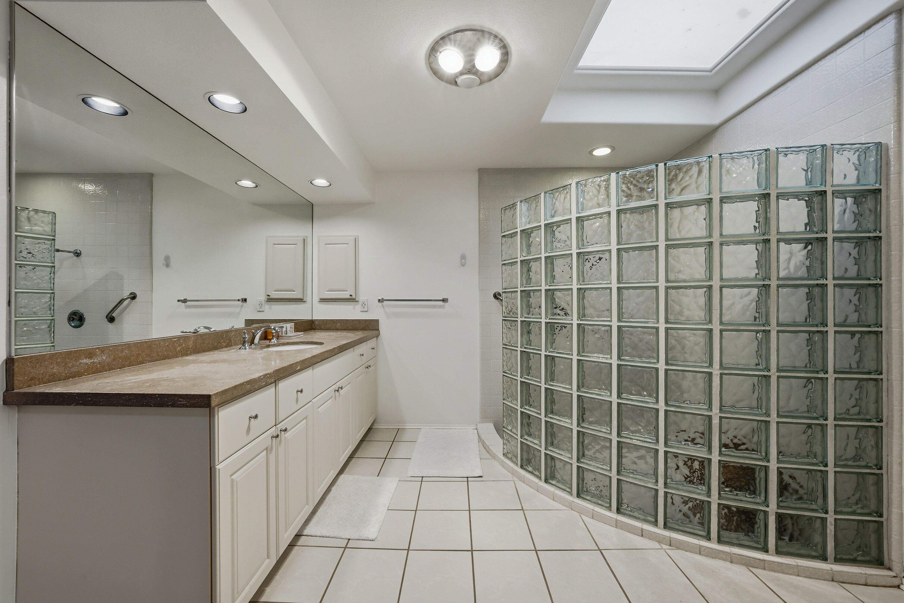 27 Cornell Drive Rancho Mirage, CA 92270 - Photo 19 of 58 a large bathroom with a double vanity sink and a mirror