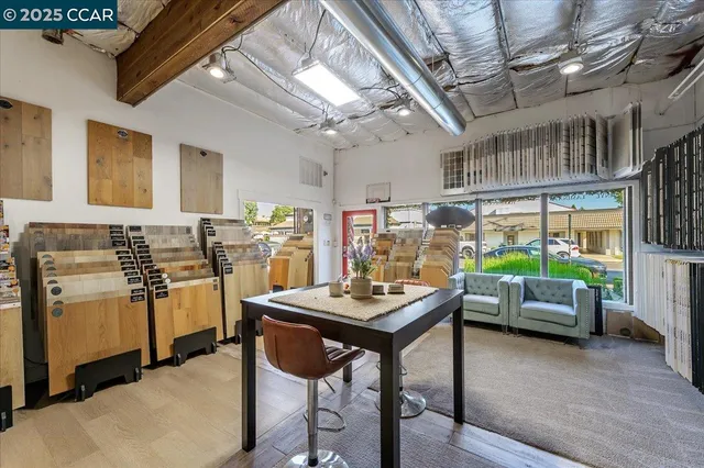 a kitchen with stove and chairs
