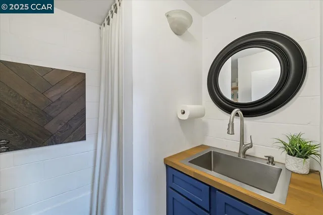a kitchen with a sink and a mirror