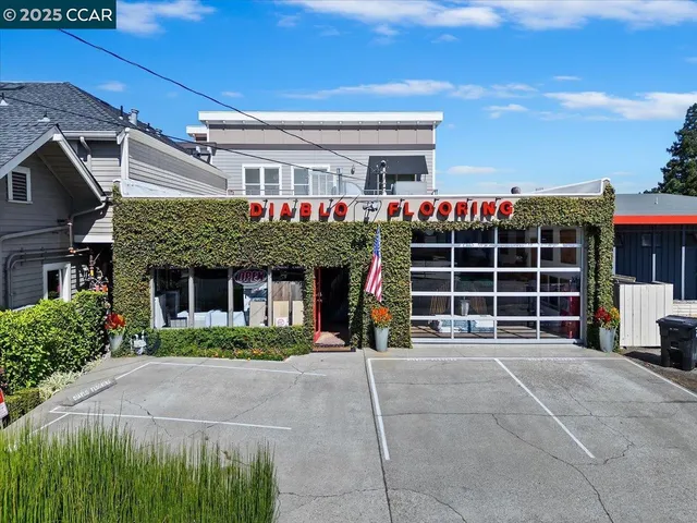 a front view of a building with a garden