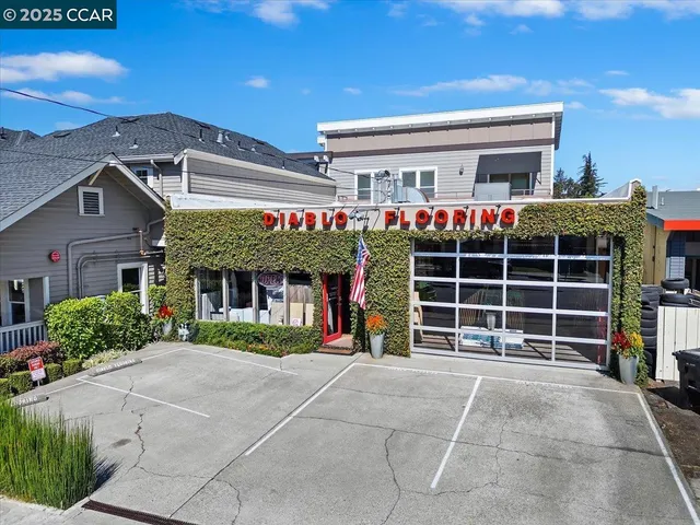 a front view of a building with a garden