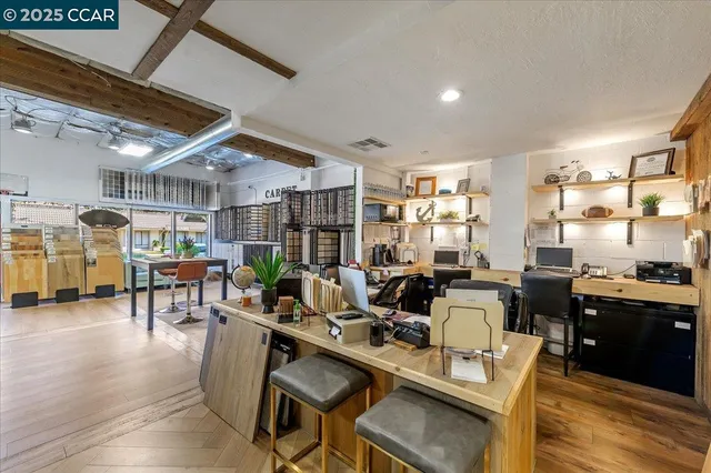 a very nice looking living room with dining room and wooden floor