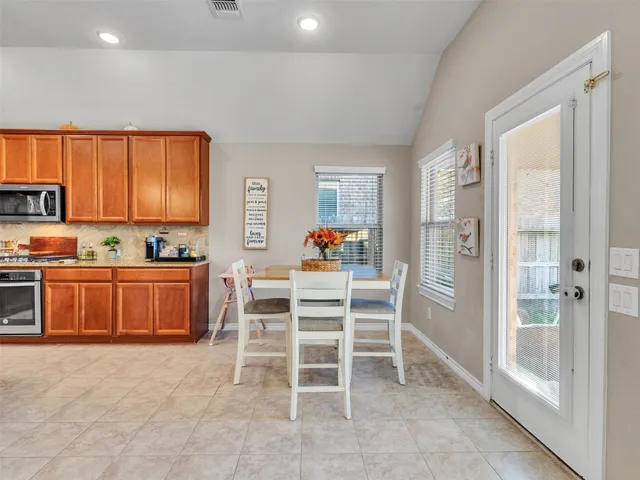 a kitchen with stainless steel appliances granite countertop a sink stove and cabinets