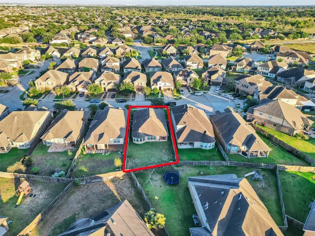 an aerial view of residential house with outdoor space and swimming pool