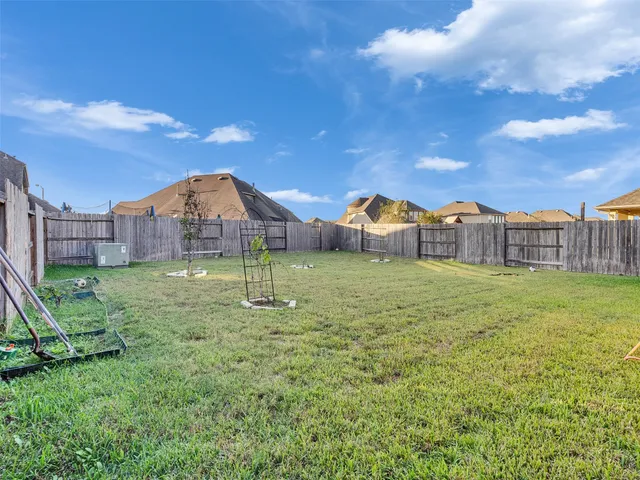 a view of a house with a big yard and large trees