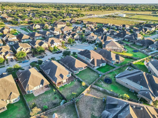 an aerial view of residential houses with outdoor space