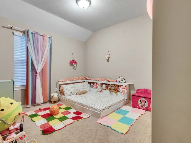 a bedroom with a bed and a dresser in it