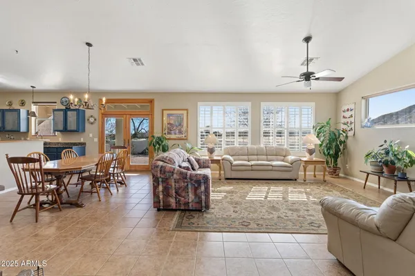 a large kitchen with stainless steel appliances a large counter top a stove and a refrigerator