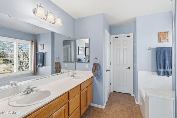 a bedroom with a bed and painting on the wall