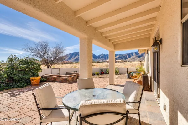 a dining room with furniture and a potted plant