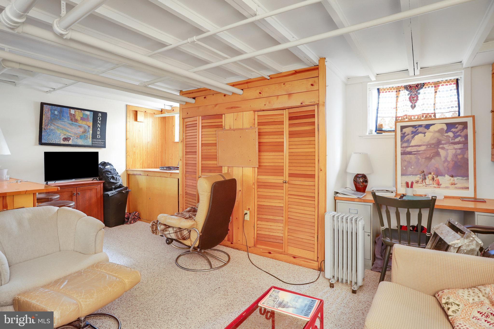 4920 43rd Place Northwest Washington, DC 20016 - Photo 12 of 25 a living room with furniture a flat screen tv and a large window