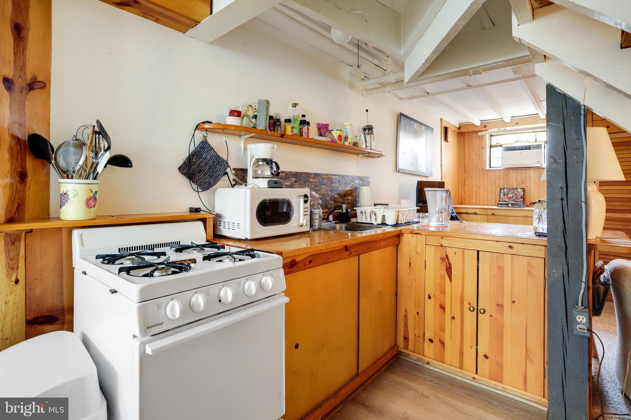 4920 43rd Place Northwest Washington, DC 20016 - Photo 15 of 25 a kitchen with sink a stove and cabinets