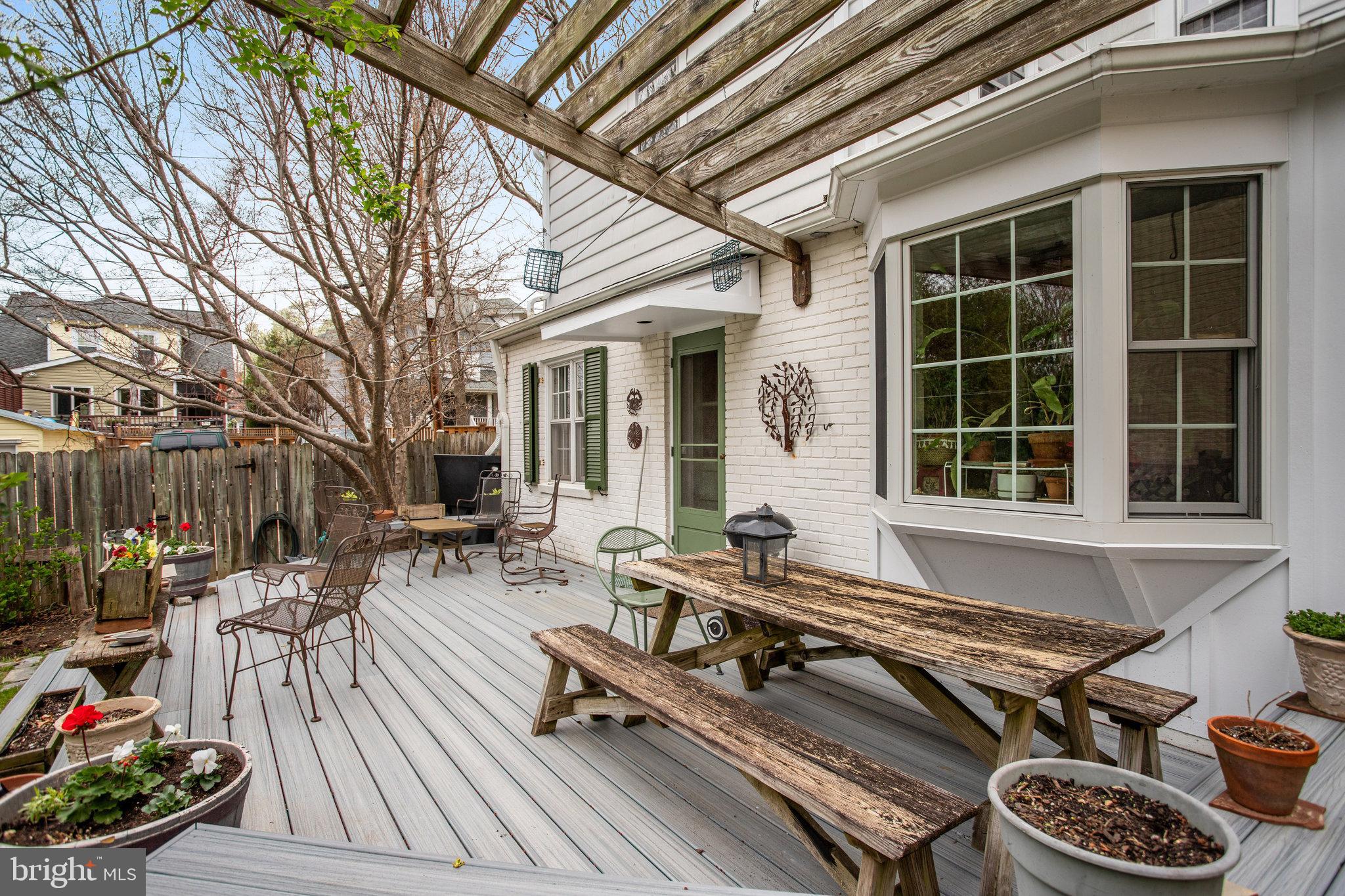 4920 43rd Place Northwest Washington, DC 20016 - Photo 23 of 25 a roof deck with table and chairs and potted plants