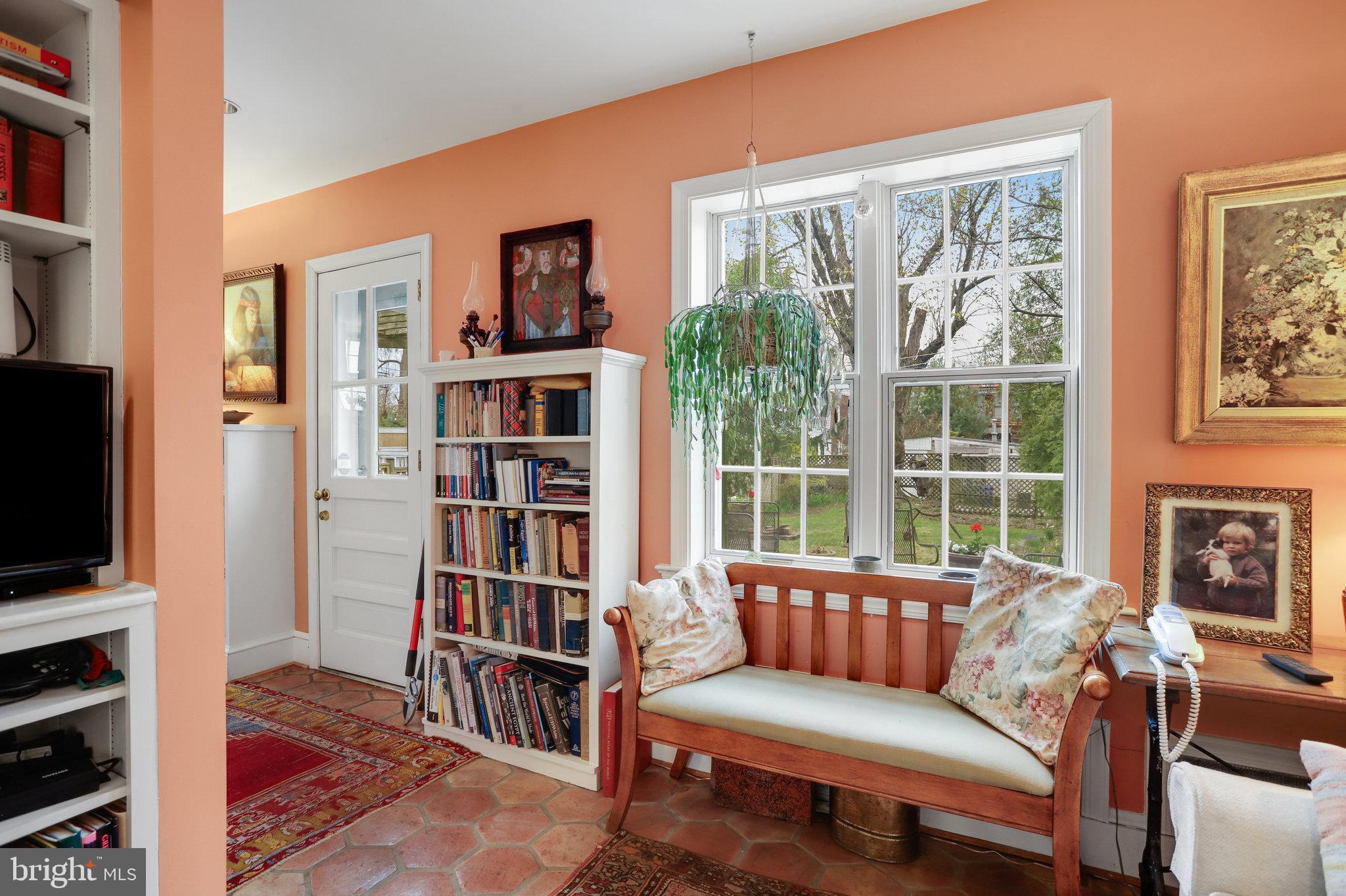 4920 43rd Place Northwest Washington, DC 20016 - Photo 7 of 25 a living room with furniture a bookshelf and a flat screen tv