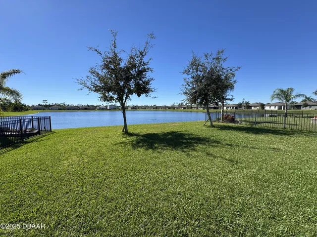a view of pool with a yard