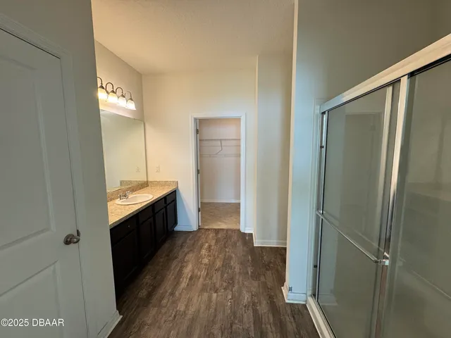 a large bathroom with a sink and mirror