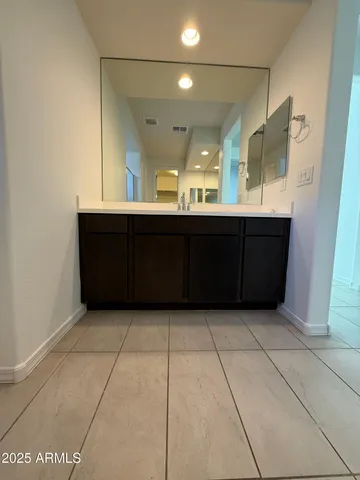 a bathroom with a vanity and a mirror