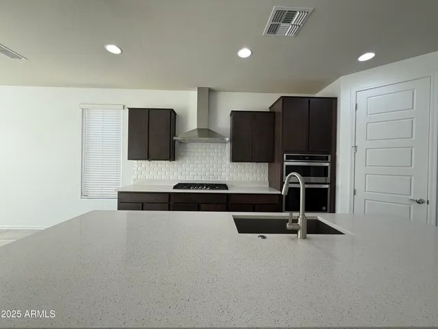 a kitchen with stainless steel appliances a refrigerator and cabinets