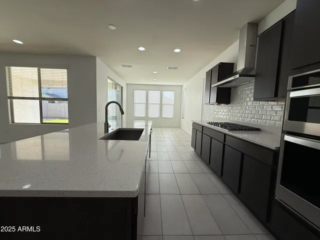 a kitchen with stainless steel appliances a sink stove and microwave
